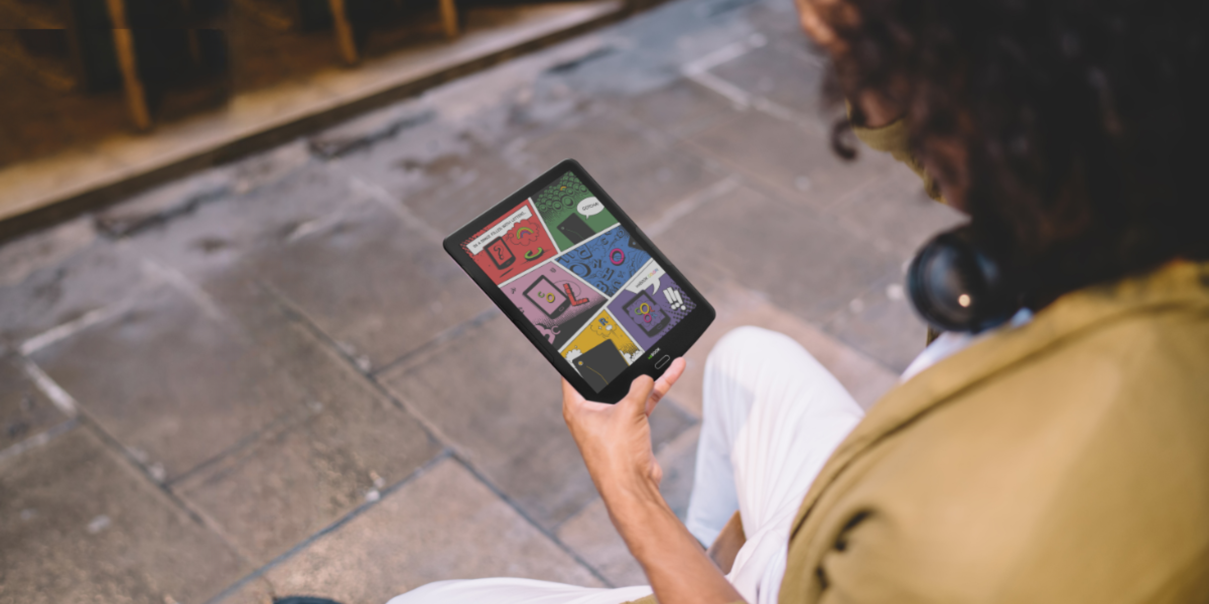 girl reading comics outside on color e ink inkBOOK Focus Color